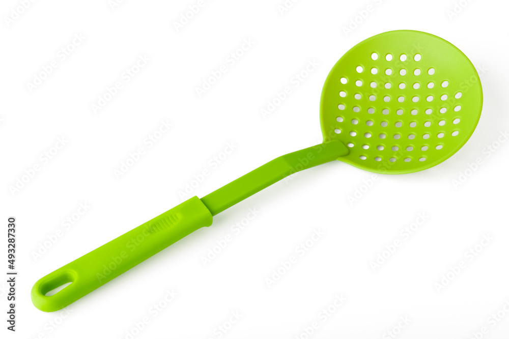 Slotted spoon, green. Isolated object on a white background. Kitchen utensils concept Slotted spoon, green. Isolated object on a white background. Kitchen utensils concept