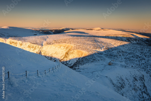 Winter view of the Meteorological Observatory on   nie  ka in the Karkonosze Mountains. The beautiful light of the rising sun creates an amazing atmosphere 