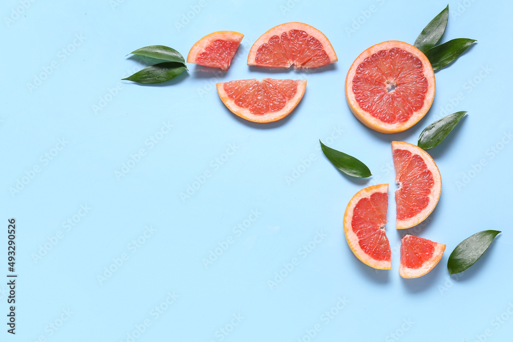 Fresh grapefruit slices on blue background Fresh grapefruit slices on blue background