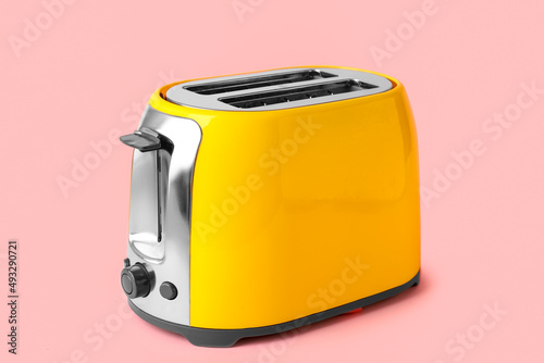 New modern toaster on pink background