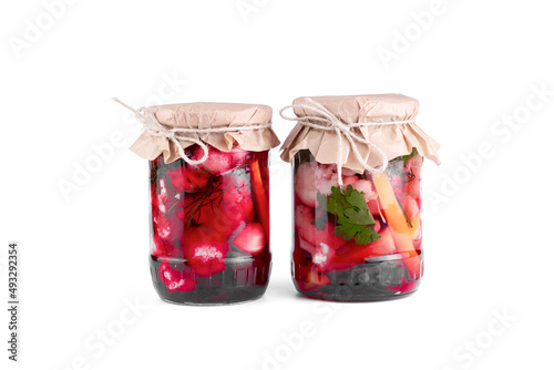 Cauliflower pickle with beetroot, marinated cauliflower pickles in jars on white isolated background.