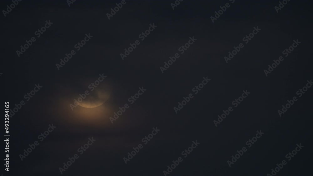 Moon rises at night during cloudy sky Moon rises at night during cloudy sky