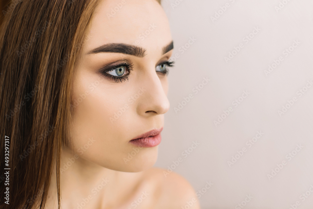 Close up fashion photo of beautiful young woman with dark straight hair and evening make up Close up fashion photo of beautiful young woman with dark straight hair and evening make up