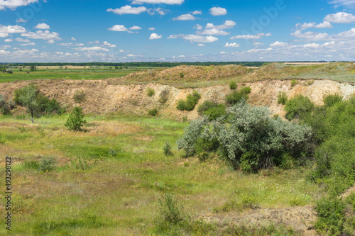 Summer landscape with overgrown crater of extinct volcano located near small river Sura in Apollonivka village  central Ukraine