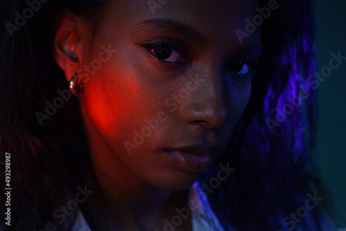 portrait of beautiful black woman, female face in neon light  photo