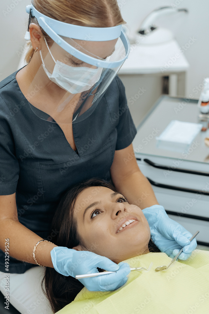 Dentist and patient in dentist office Dentist and patient in dentist office