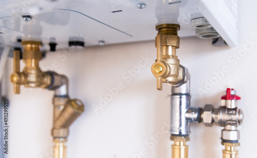 Pipes and taps of heating boiler close-up