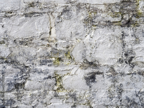 Old white, painted stone wall background.
