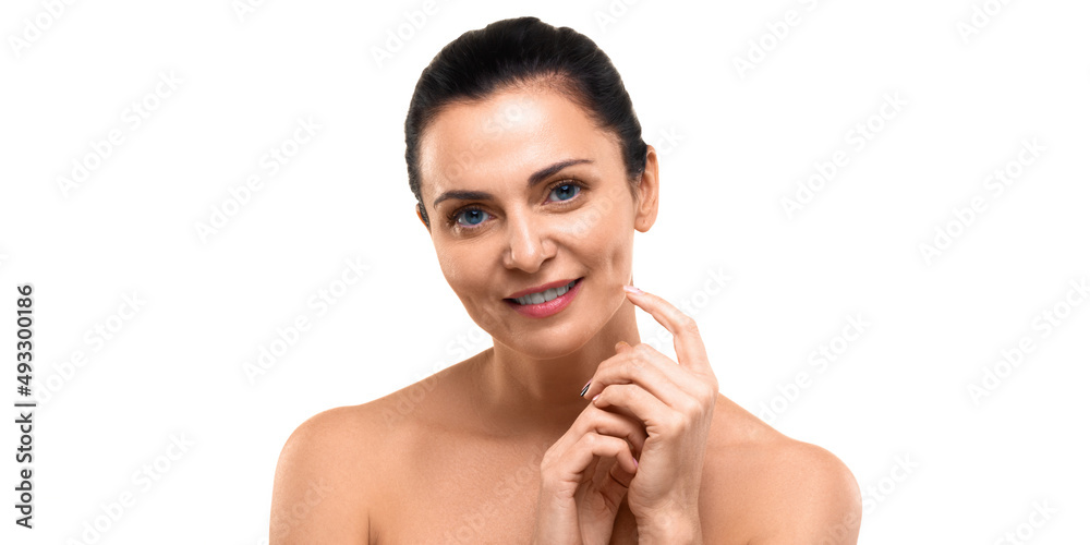 A 40 years old woman looking at camera and smiling - isolated on white background.
