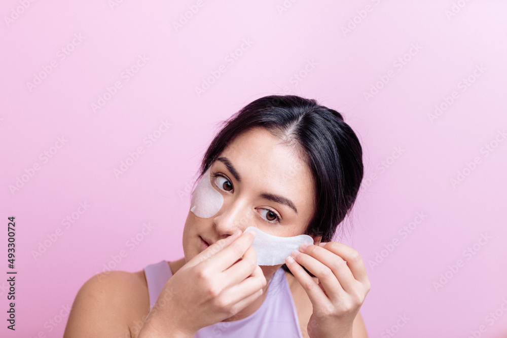 Girl Applying Eye Patches During Self Care Routine Girl Applying Eye Patches During Self Care Routine