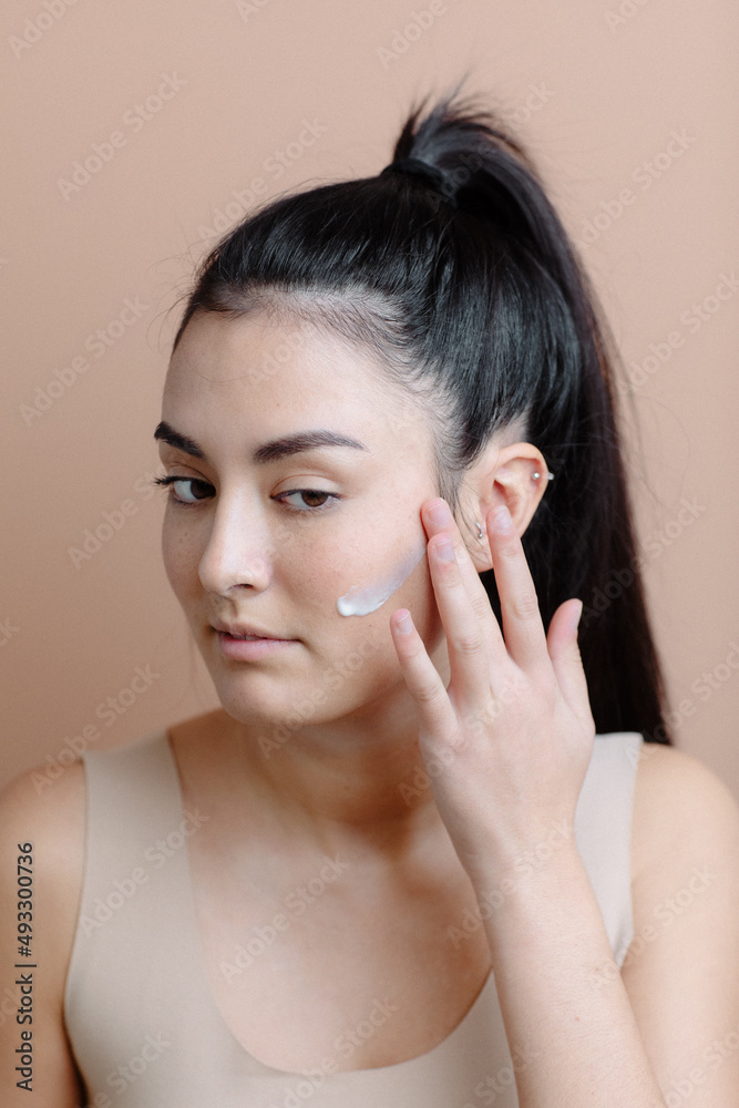 Young Japanese Girl Applying Face Cream With Hands Young Japanese Girl Applying Face Cream With Hands