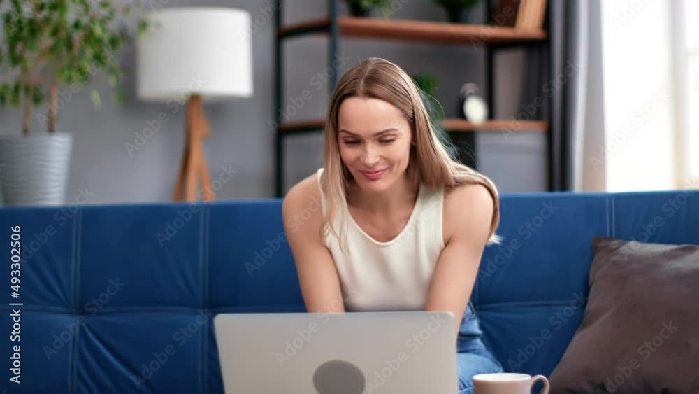 Amazed young woman surprised having good news received lucky online message email use laptop at home Amazed young woman surprised having good news received lucky online message email use laptop at home