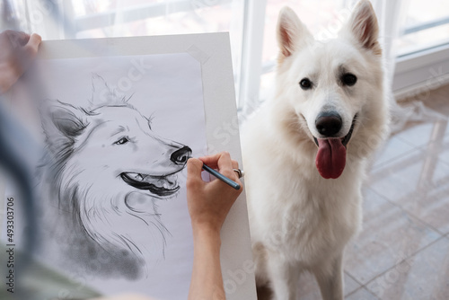 Crop woman drawing dog with tongue out
