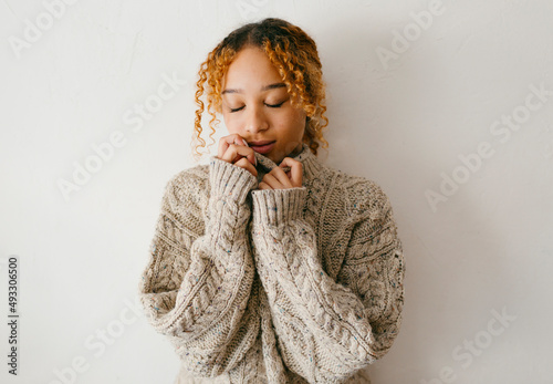 Teenage inside a big wool sweater feeling hygge season photo