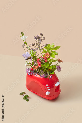 Red toaster with colorful spring flowers photo