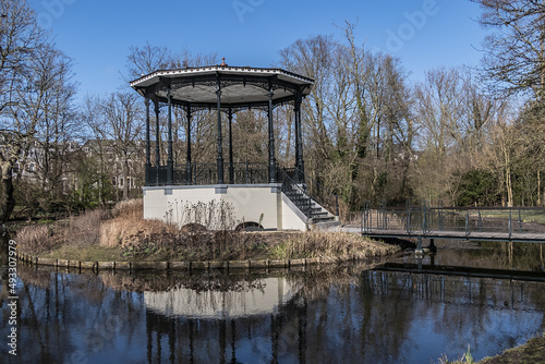 Bandstand on a round island in the pond of the Vondelpark in Amsterdam, built in 1873. Vondelpark was opened in 1865. Amsterdam, the Netherlands.