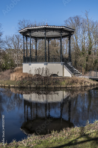 Bandstand on a round island in the pond of the Vondelpark in Amsterdam, built in 1873. Vondelpark was opened in 1865. Amsterdam, the Netherlands.