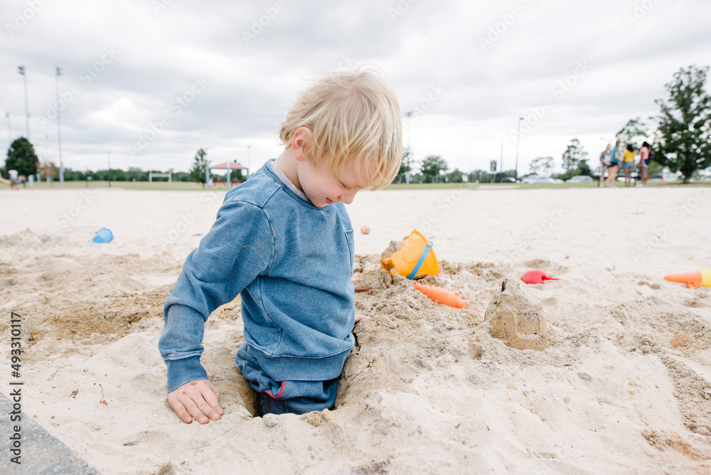 Boy sitting in hole Boy sitting in hole