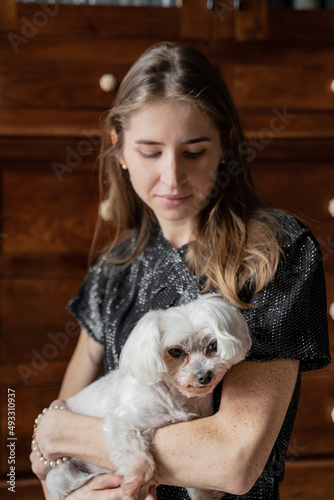 Woman Holding Cute White Dog  photo