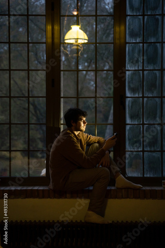 Man using phome at home at night  photo