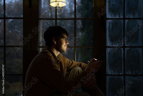 Man using phome at home at night  photo