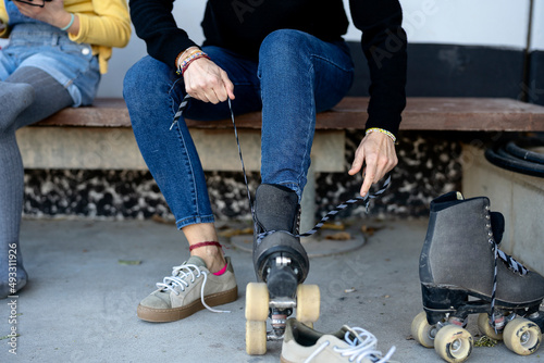 Wallpaper Mural Faceless woman tying laces on quad skates in park Torontodigital.ca