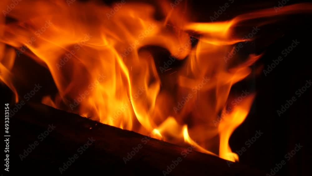 Close up piece of wood burning in flames in the fireplace. Slow motion 4K Close up piece of wood burning in flames in the fireplace. Slow motion 4K