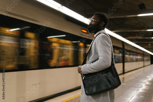 Black male in mask in metro photo