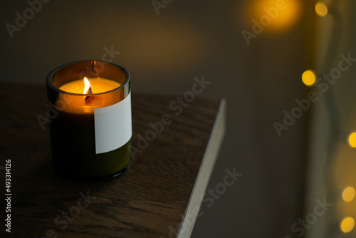 Burning natural candle with a wooden wick photo