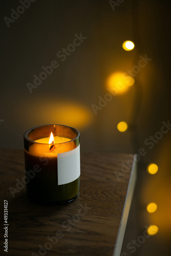 Burning natural candle with a wooden wick