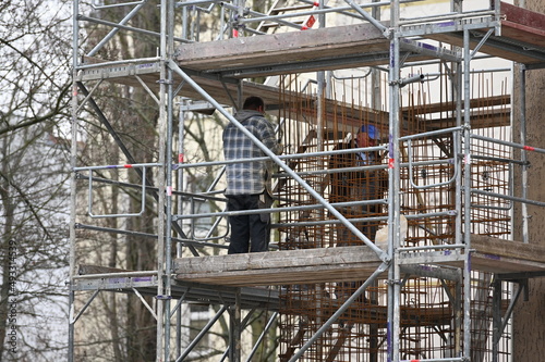 Two workers on a scaffolding in Berlin-City.