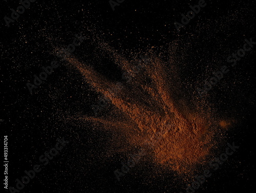 Cinnamon powder isolated black, top view