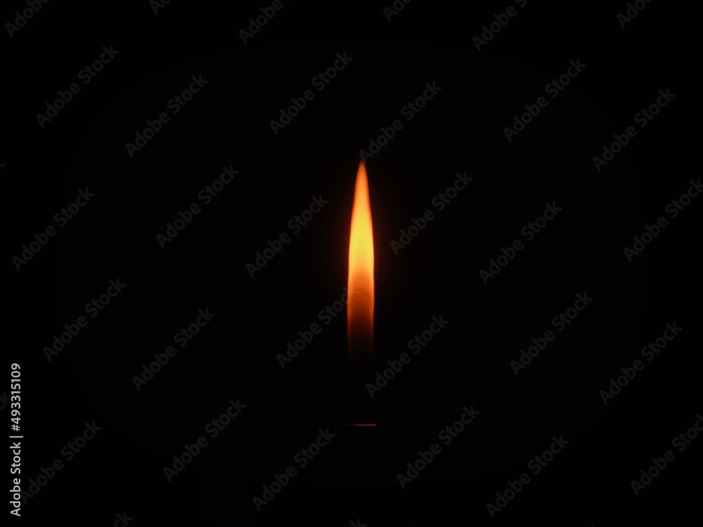 burning candle on black background burning candle on black background