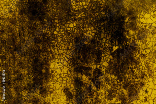 Cracked old concrete floor with yellow overlay for texture background