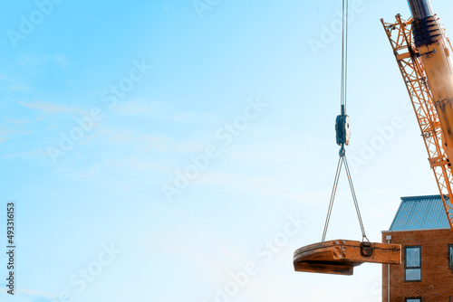 Photography Mobile crane lifting its counterweight during crane assemling and preparations on building site