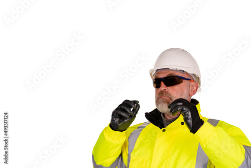 A construction worker in hi-viz and safety glasses isolated on white background. Safety on construction site banner concept