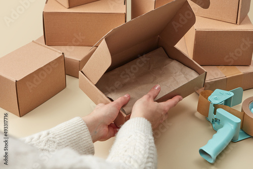 Delivery service worker packing parcel boxes photo
