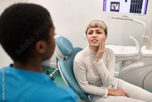 Young patient complaining to dentist