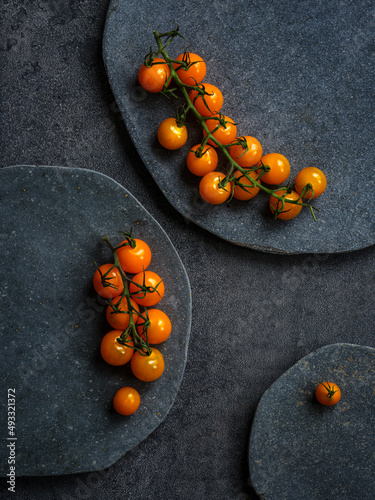 Plates of orange cherry Tomatoes photo