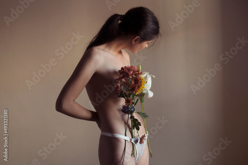 Nude woman with flowers