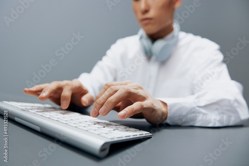 man sitting at a table with a keyboard in the office isolated background