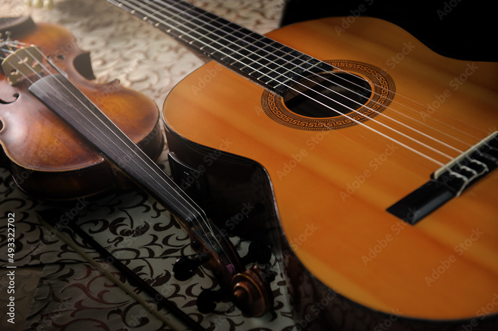 classical acoustic guitar and violin on the table classical acoustic guitar and violin on the table