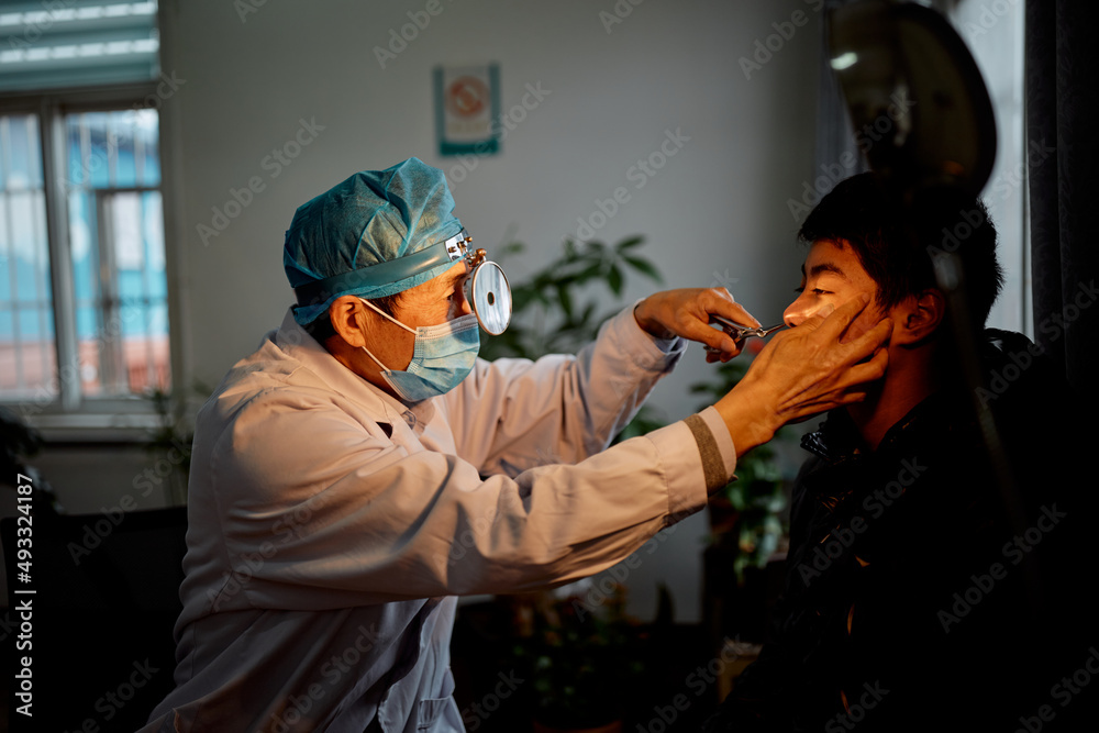 Doctor performing a test on a teenager at the hospital Doctor performing a test on a teenager at the hospital