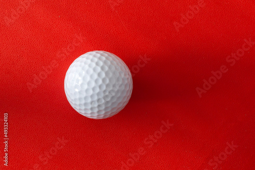 Golf ball on a red background