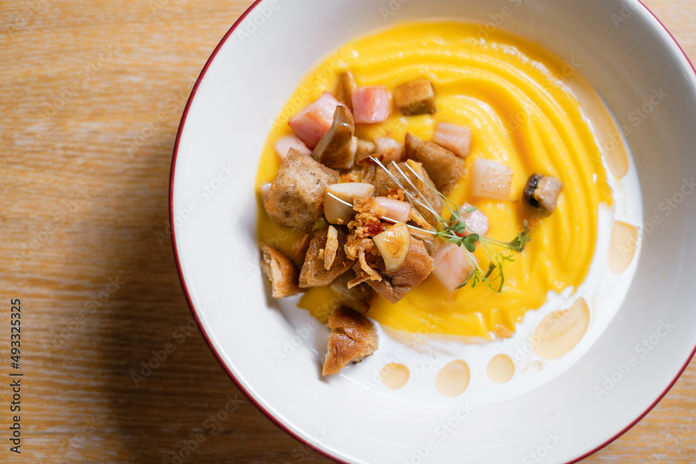 Pumpkin puree with ham and croutons. Menu design concept for a restaurant. Pumpkin puree with ham and croutons. Menu design concept for a restaurant.