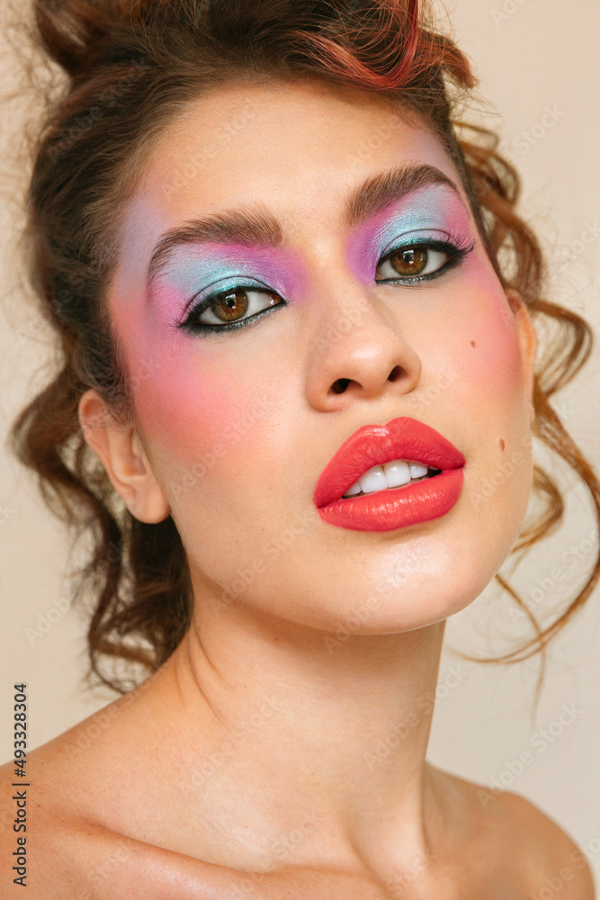 © Ángela Rober/Stocksy - Young model with eighties make-up looking at the camera © Ángela Rober/Stocksy - Young model with eighties make-up looking at the camera