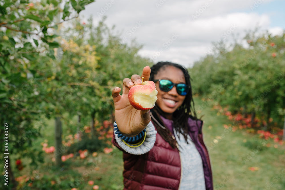 Smiling black girl holding an apple