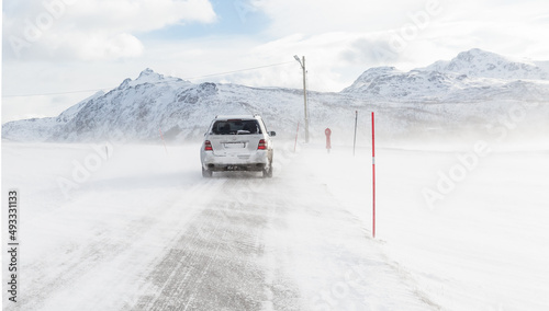 Bild auf Leinwand card driving through bad weather condition with heavy wind and snow