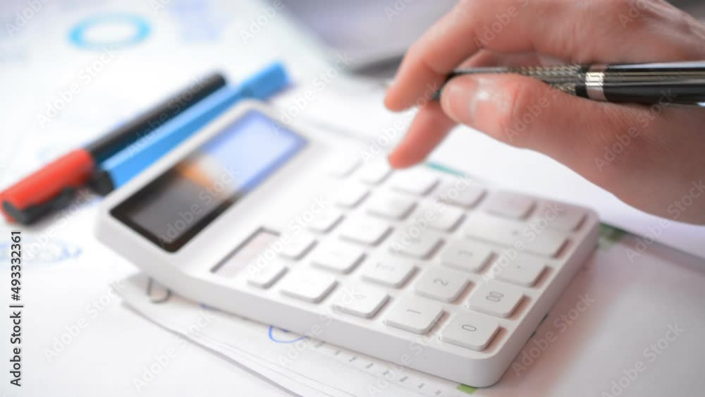 White digital calculator close on table White digital calculator close on table