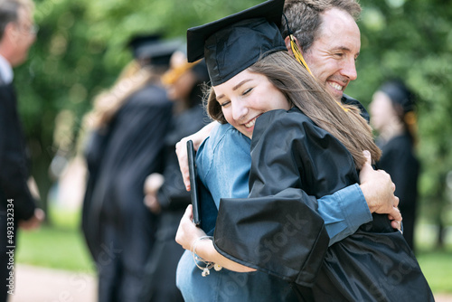 Grad: Proud Parent Hugs New Graduate photo